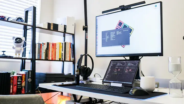 Modern video editing workspace setup with dual monitors, camera, and marketing performance metrics overlays.